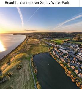 an aerial view of a park next to a body of water at Stunning 2 bed house near coastal path/lake/beach in Llanelli