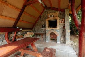 an outdoor kitchen with a stone oven in a cabin at Chalúpka Lavender in Zázrivá