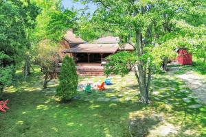 an aerial view of a house with a yard at Peaceful Lakefront Cabin Retreat with Hot Tub! 