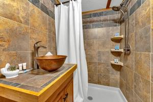 a bathroom with a sink and a tub and a shower at Peaceful Lakefront Cabin Retreat with Hot Tub! 