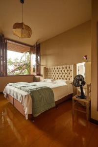um quarto com uma cama grande e uma janela em Casa Pinheiral em Bragança Paulista
