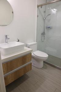 a bathroom with a sink and a toilet and a shower at Bella Studio Apartments - Lux Loft in Kingston