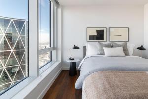 a bedroom with a bed and a large window at Award winning 1 bedroom apartment - extended stay in Calgary
