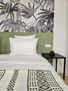 a bedroom with a large bed with a plant wall at Riad Coconut in Marrakech