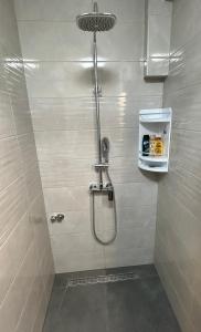 a shower stall in a bathroom with a shower at Apartment In Time in Sesvete