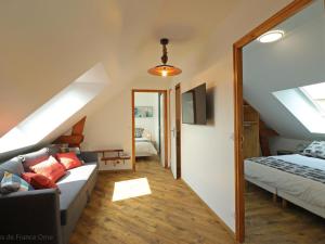a living room with a couch and a bed at Maison moderne avec jardin clos et SPA privatif en Normandie - FR-1-497-189 in Athis