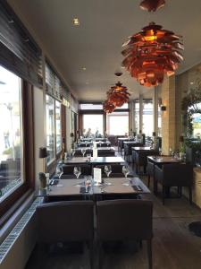 a row of tables and chairs in a restaurant at Sleep at Sea in Nieuwpoort