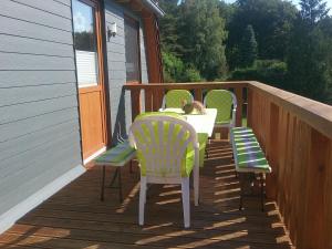 un porche con 3 sillas y una mesa con un gato. en Ückeritz, Villa Wald-Eck - Dachgeschoss, en Ückeritz 23 fotos más