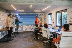 a group of people in a room with a presentation at Hotel Montanova in Zlatibor