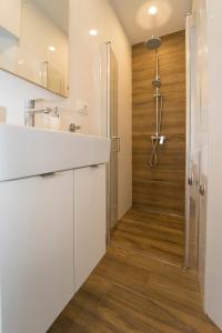 a bathroom with a shower and a white counter top at Sunny Town in Korčula +47 photos