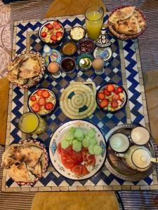 a table topped with plates of food on a table at Atlas Surf Morocco in Tamraght Ouzdar