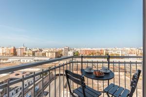 - Balcón con mesa y sillas y vistas a la ciudad en Capruzzi Guest House en Bari