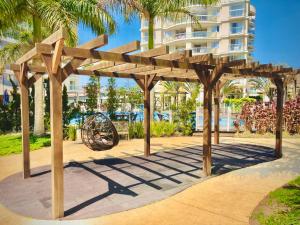 a wooden pergola in front of a building at Condomínio Encantador - Beto Carrero - 3 quartos in Penha