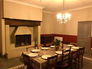a dining room with a table and a fireplace at Dordogne, Le Cambou, 5 ch avec piscine et terrain 3 ha in Vergt-de-Biron