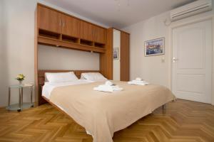 a bedroom with a large bed with towels on it at Sunny Town in Korčula