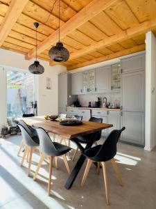 a kitchen with a wooden table and chairs at Casa Mido Badacsony in Badacsonytomaj