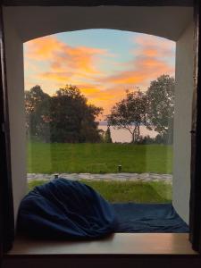 a window with a view of a field of grass at Casa Mido Badacsony in Badacsonytomaj