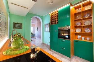 a kitchen with green cabinets and a counter at Christa Guest House in Massa Lubrense +34 photos