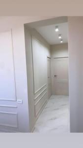 a room with white walls and two white doors at Lidiani Guest House in Gyumri