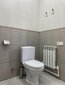 a bathroom with a white toilet in a room at Lidiani Guest House in Gyumri