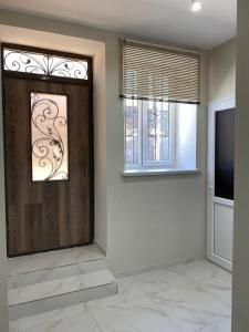 a living room with a door and a television at Lidiani Guest House in Gyumri