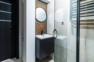 a bathroom with a sink and a mirror at Apartament DWORCOWA 86 in Bydgoszcz