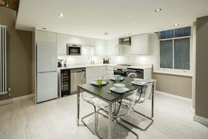 a kitchen with a table and chairs in it at Central, Kensington, 3Beds, Cosy, Parks, Pubs in London