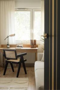 a room with a desk and a chair in front of a window at Panorama Apart 23 in Olsztyn