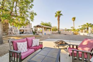 a patio with two chairs and a table at Lake Havasu Oasis with Lake View, 1 Mi to Beach! in Lake Havasu City