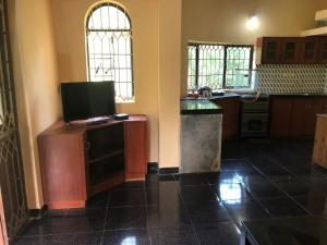 a kitchen with a tv on top of a counter at Safe Home Stay in Cansaulim