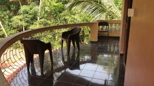 two chairs sitting on a balcony with a fence at Safe Home Stay in Cansaulim