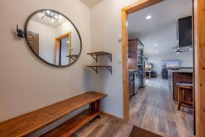 a hallway with a mirror and a wooden bench at Buena Vista Mountain Retreat - Ultimate Privacy with Spa & Unbeatable Views in Buena Vista