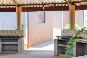 two benches under a pavilion in a courtyard at Makobaneng Guesthouse in Ga-Raphokola