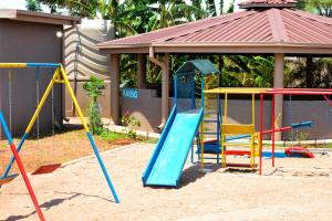 a playground with colorful playground equipment in front of a gazebo at Makobaneng Guesthouse in Ga-Raphokola