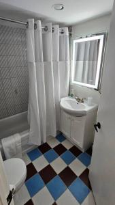 a bathroom with a white toilet and a sink at Le Nid d'Aigle in Beaupré