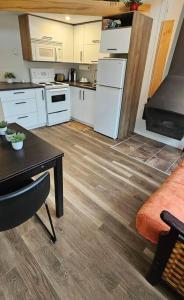 a kitchen with a table and a kitchen with white appliances at Le Nid d'Aigle in Beaupré