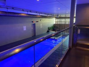 a swimming pool in a building with blue lighting at Family oriented Downtown Toronto 2BDRM Condo with Parking & office space in Toronto
