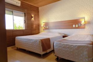 Ένα ή περισσότερα κρεβάτια σε δωμάτιο στο Pousada Costa Doce