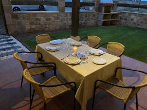 a table with plates and wine glasses on it at La Traviesa de la Demanda in Cabezón de la Sierra +47 photos