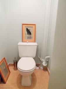 a bathroom with a toilet with a picture of a dolphin at Olympic Games 2024_Charming Stay in Fontenay-sous-Bois