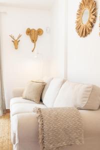 a living room with a white couch and a mirror at Palm Beach House in Corralejo +61 photos
