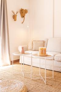 a living room with a couch and two tables at Palm Beach House in Corralejo