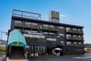 a black building with a clock on top of it at InnCocoSumu？ - Vacation STAY 04627v in Kirishima