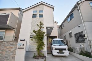 una furgoneta blanca estacionada frente a una casa en Magical Dream House ★ Maihama - Vacation STAY 12402 en Tokio