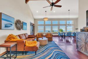 a living room with a couch and chairs and a table at Dream Weaver House with Hot Tub and Ocean View! in Manchester
