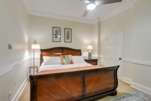 a bedroom with a bed with a wooden headboard at Spacious Downtown New Orleans Vacation Rental in New Orleans