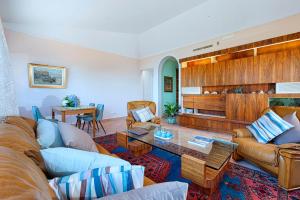 a living room with a couch and a table at Christa Guest House in Massa Lubrense