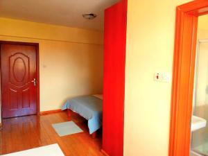 a room with a door and a room with a bed at Lavington Room1 in Nairobi