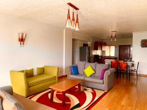 a living room with two couches and a table at Lavington Room1 in Nairobi