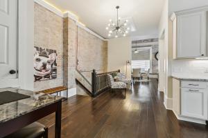 a kitchen and living room with a brick wall at Spacious Downtown New Orleans Vacation Rental in New Orleans
